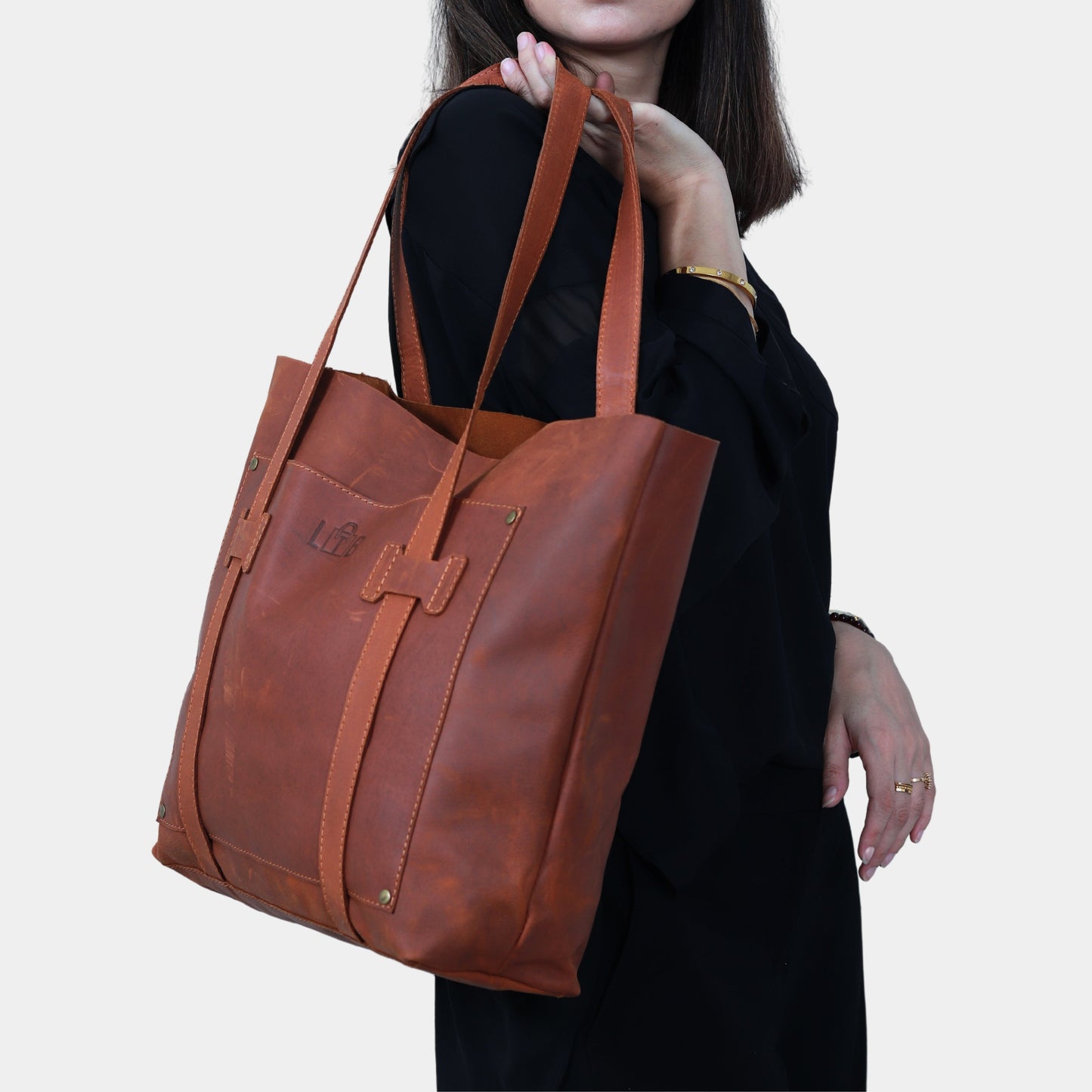 Woman in black dress is holding in hands Large Brown Leather Tote by LTB store