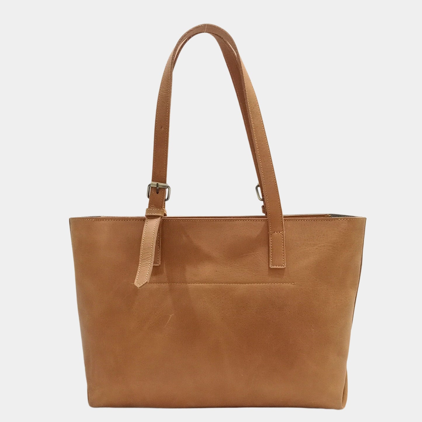Backside of formal brown leather tote for women with top zip closure featuring vintage brass hardware