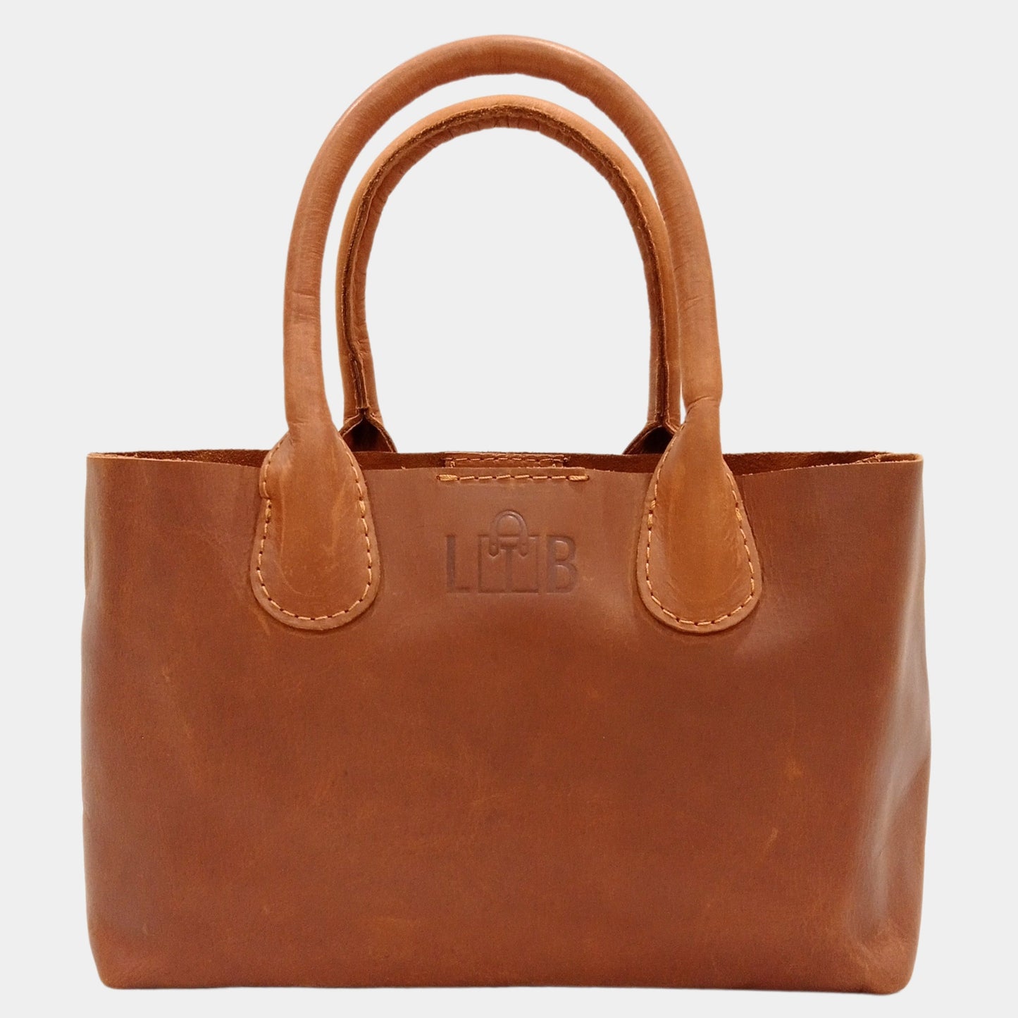 Small handy brown leather tote bag with soft reinforced handles providing comfortable grip