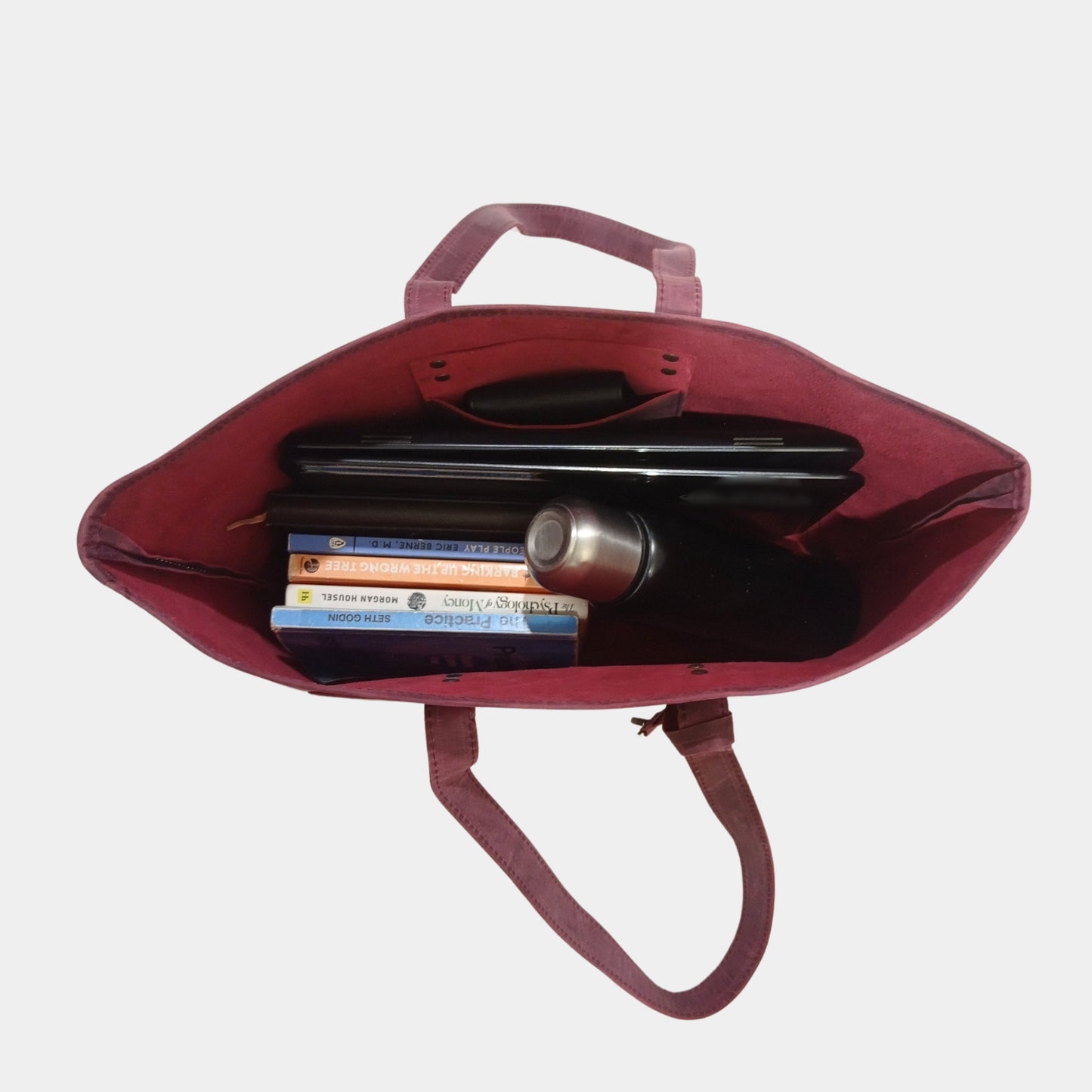 Trendy Work Leather Tote holding water bottle, books, and laptop while wallet is hanging pocket