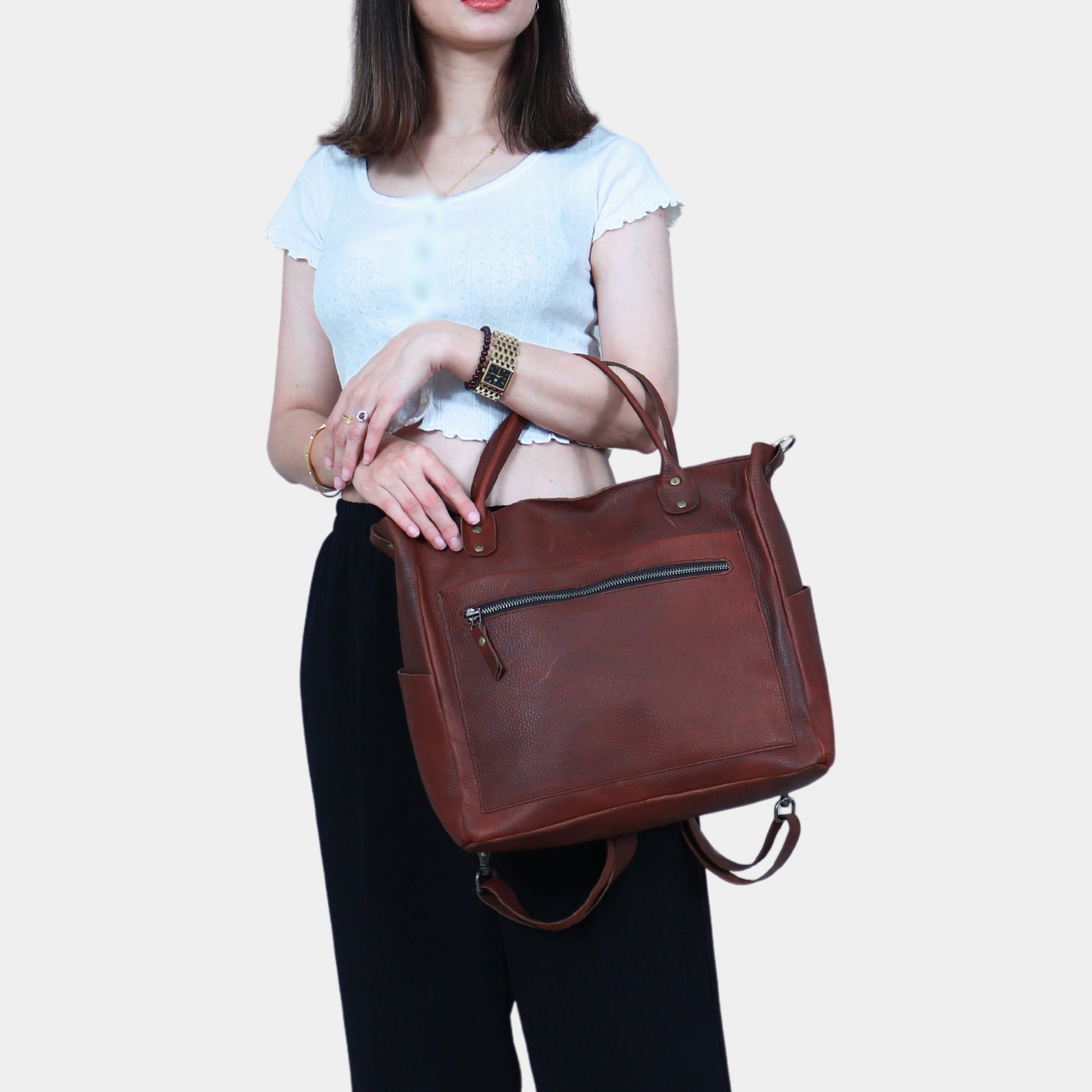 Girl carrying Brown Bella Leather Tote Bag by LTB Australia in her hands  