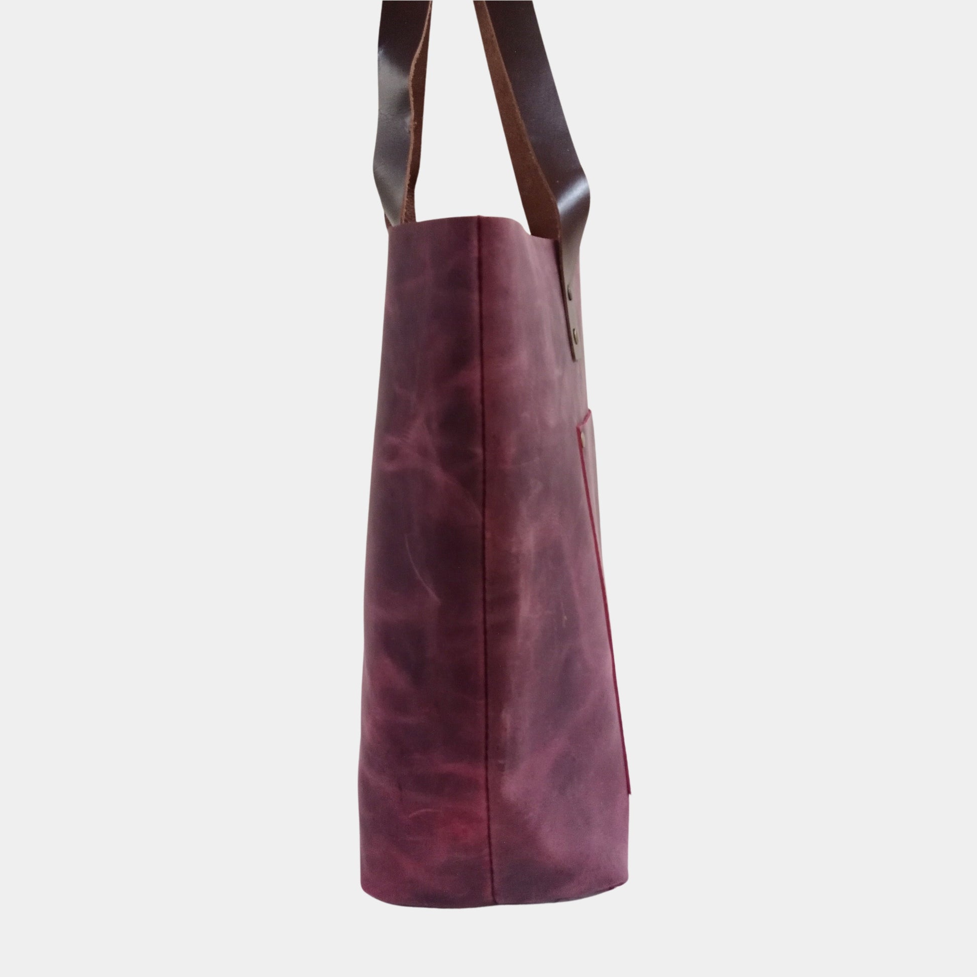 Side view showing width of Burgundy large leather tote bag with soft handles