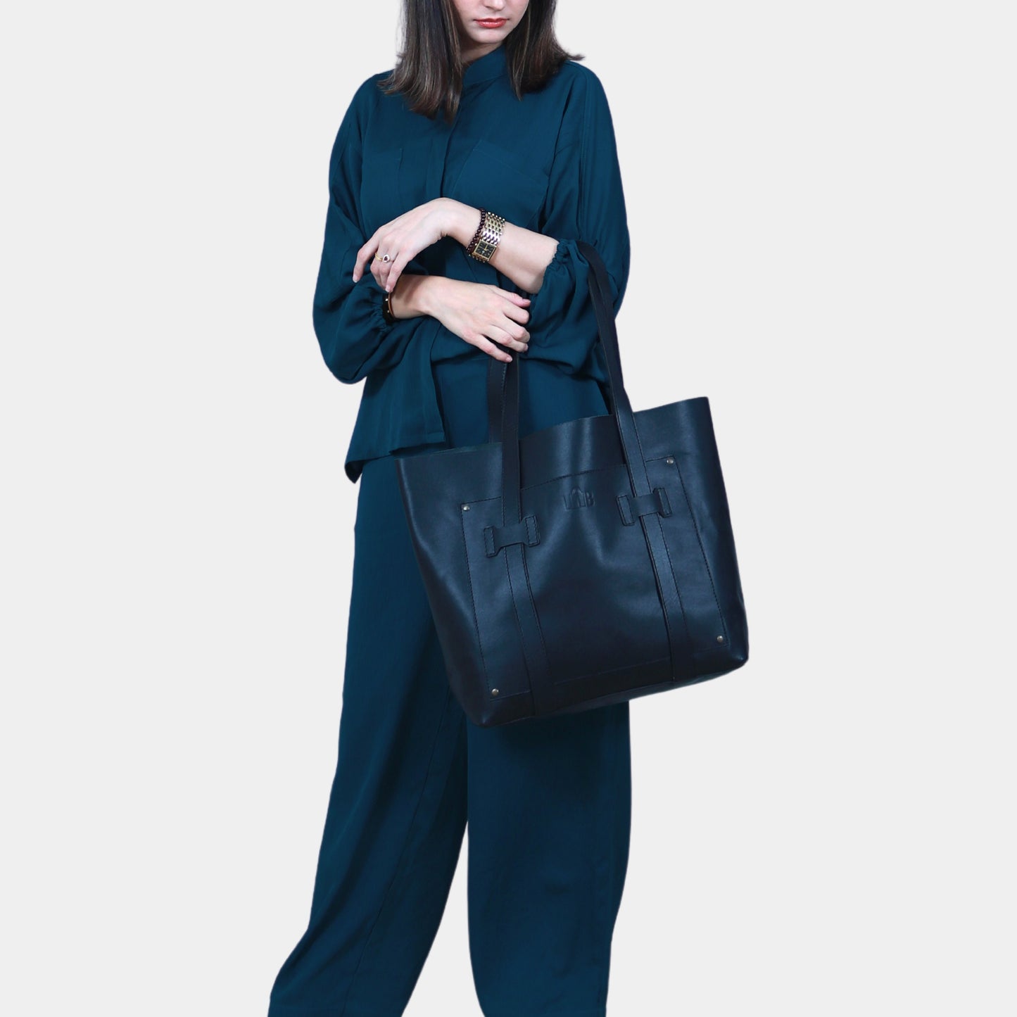 Women in sea green dress Elegantly holding Large office Tote bag in her hands