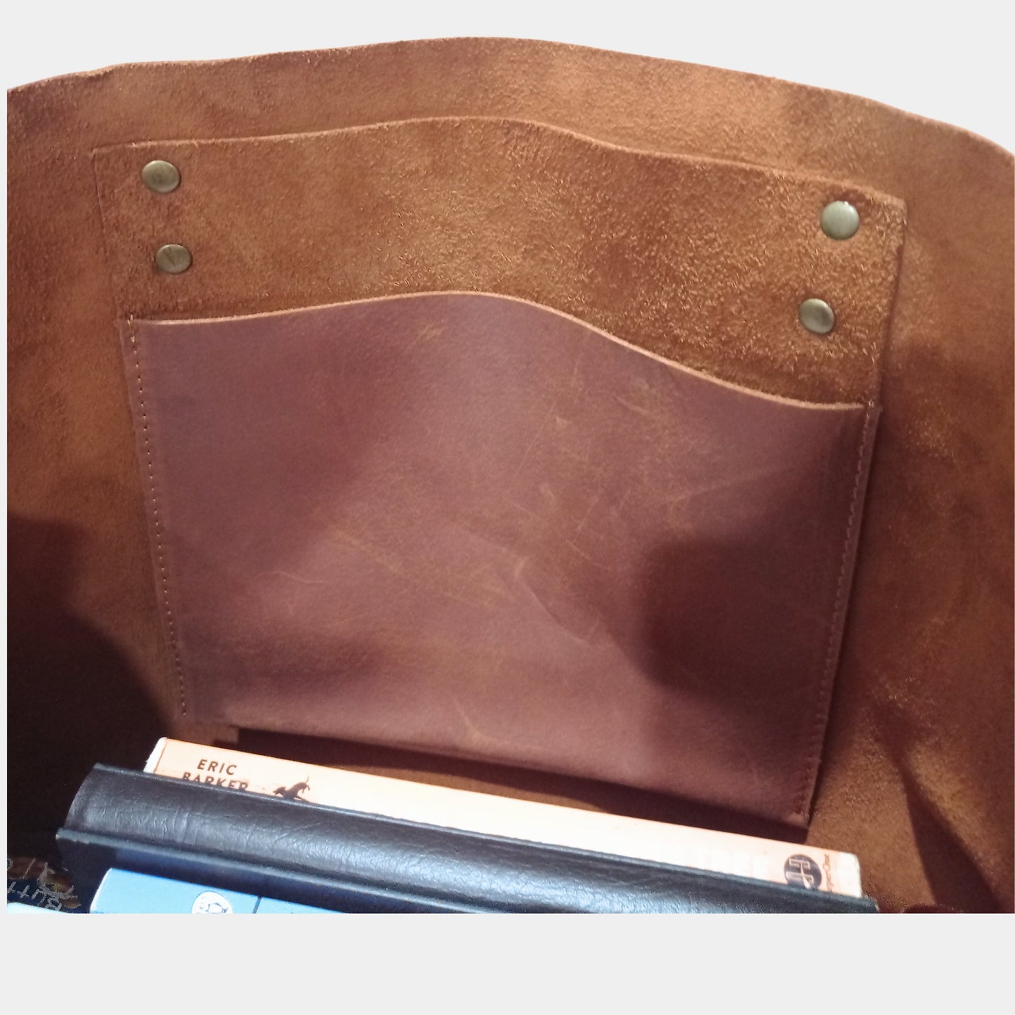 Inside of elegant Willow brown leather tote showing hanging organization pocket and notebooks inside