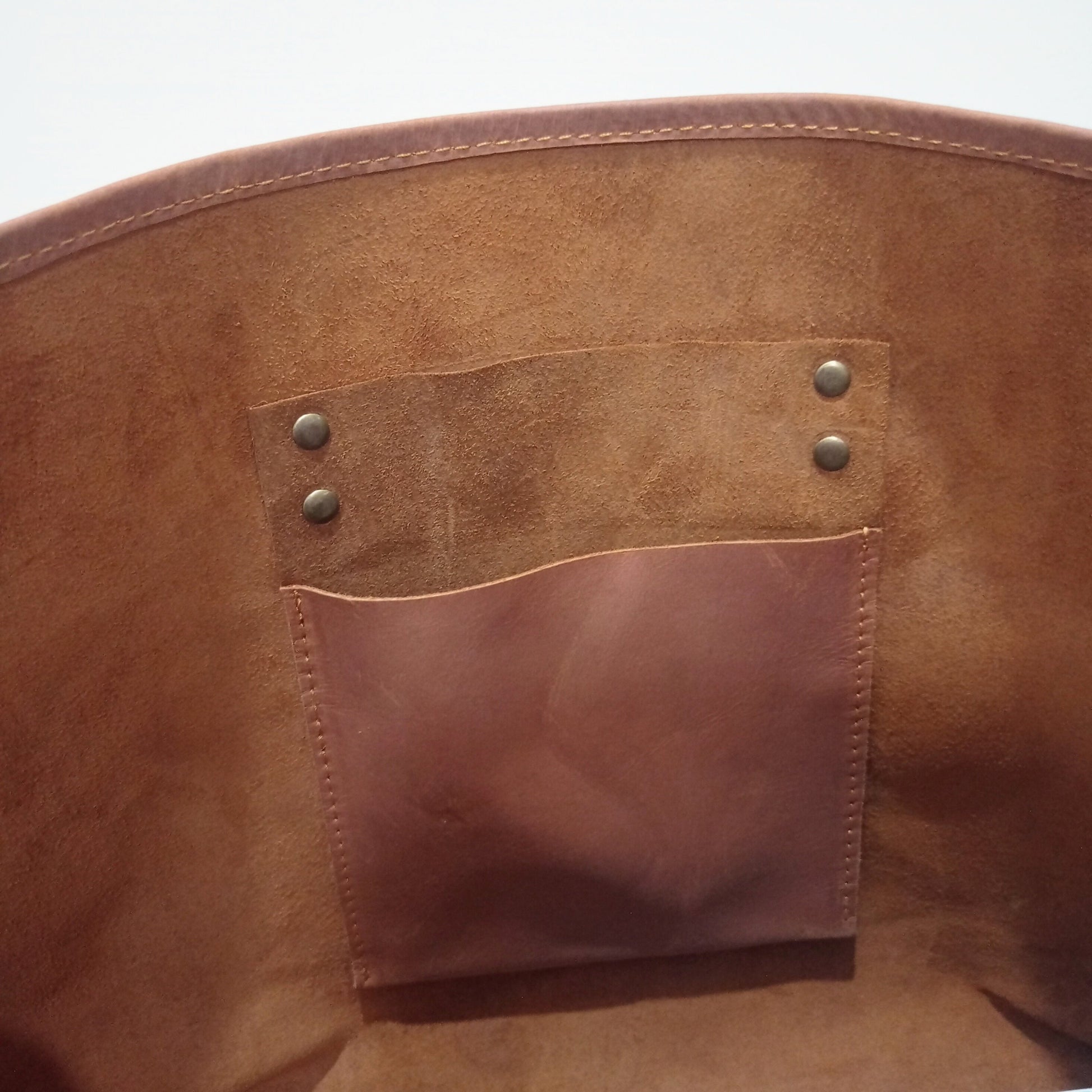 Inside unlined interior of Mila Leather Large Brown Tote showing Hanging organization pocket