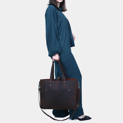 Teenage girl posing with stylish Ivy leather tote in her hands by soft dual lined handles