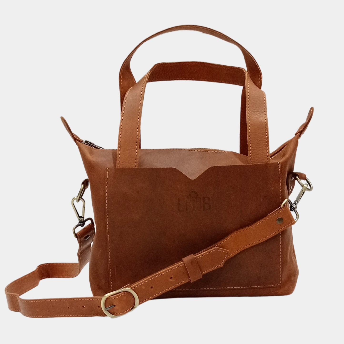 Minimalist design cross body leather tote bag showing its removable strap attached to bag 