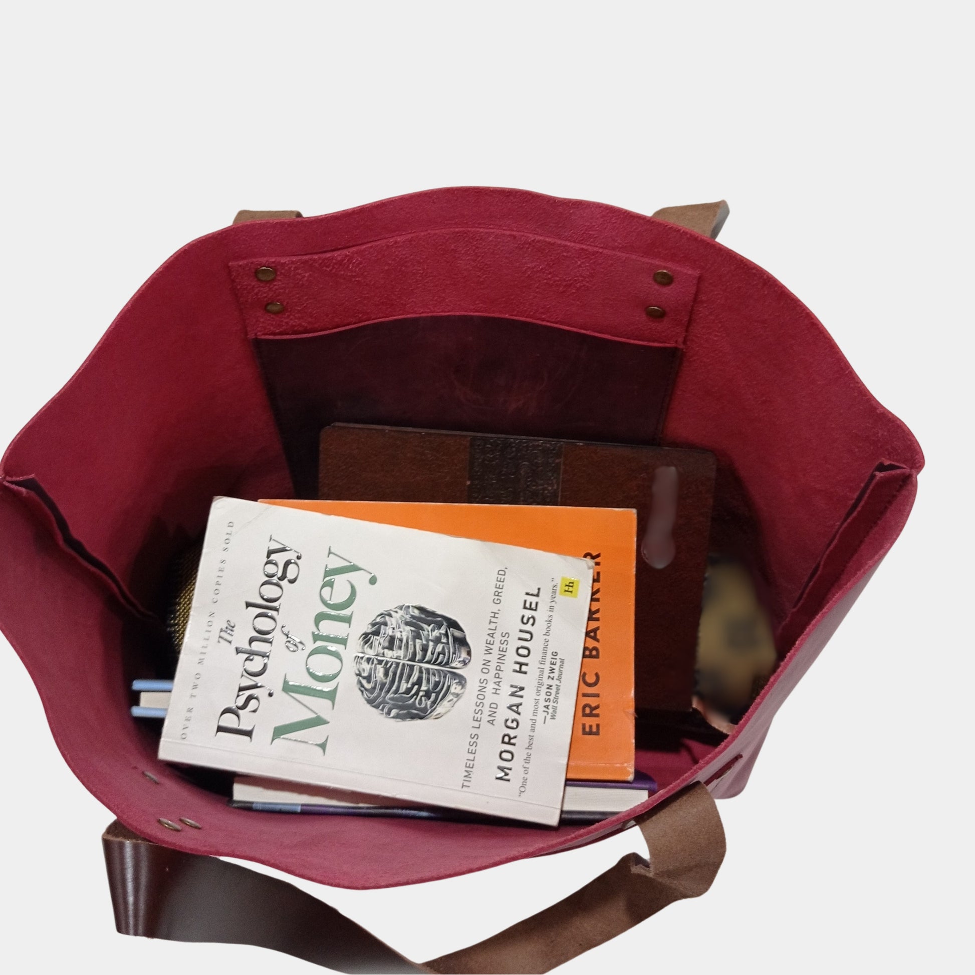 Soft unlined interior of large Lily Leather Tote with spacious hanging pocket inside sorting college books 