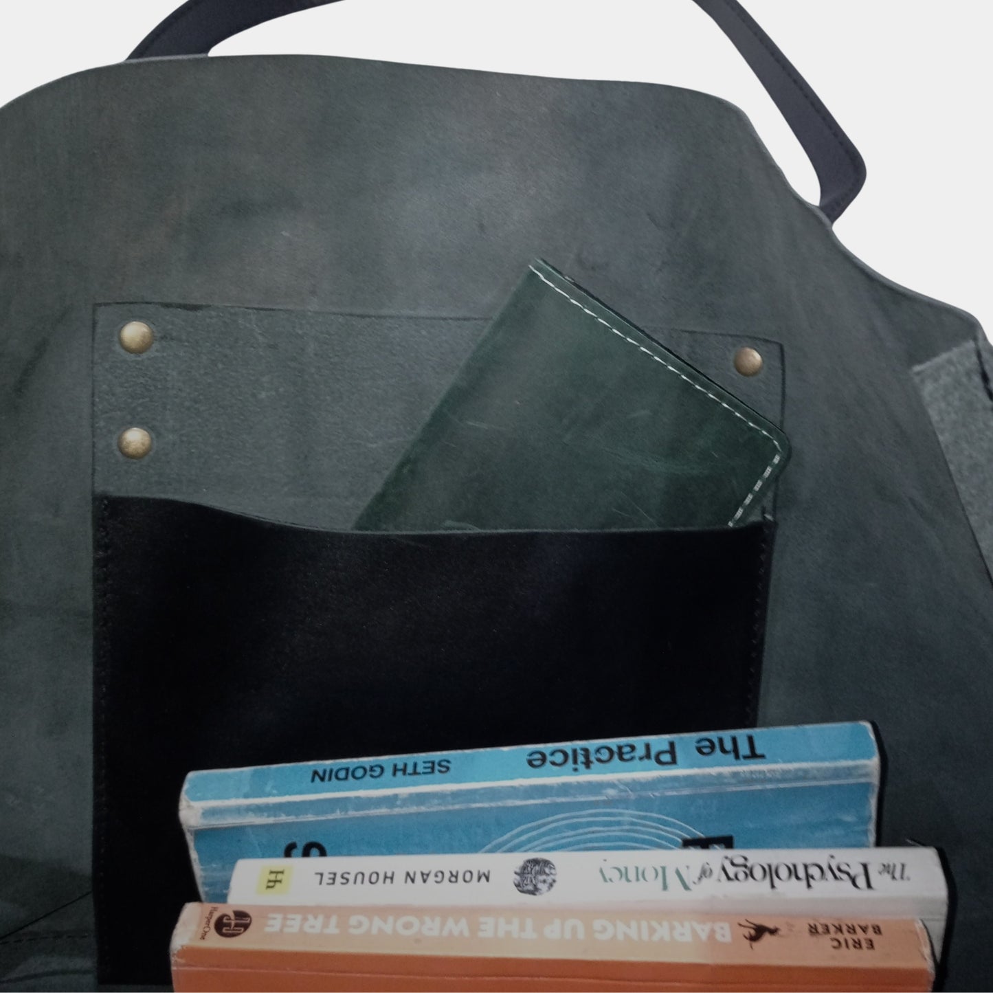 Inside of Large Black Leather Tote sorting your books while  green long wallet in hanging pocket