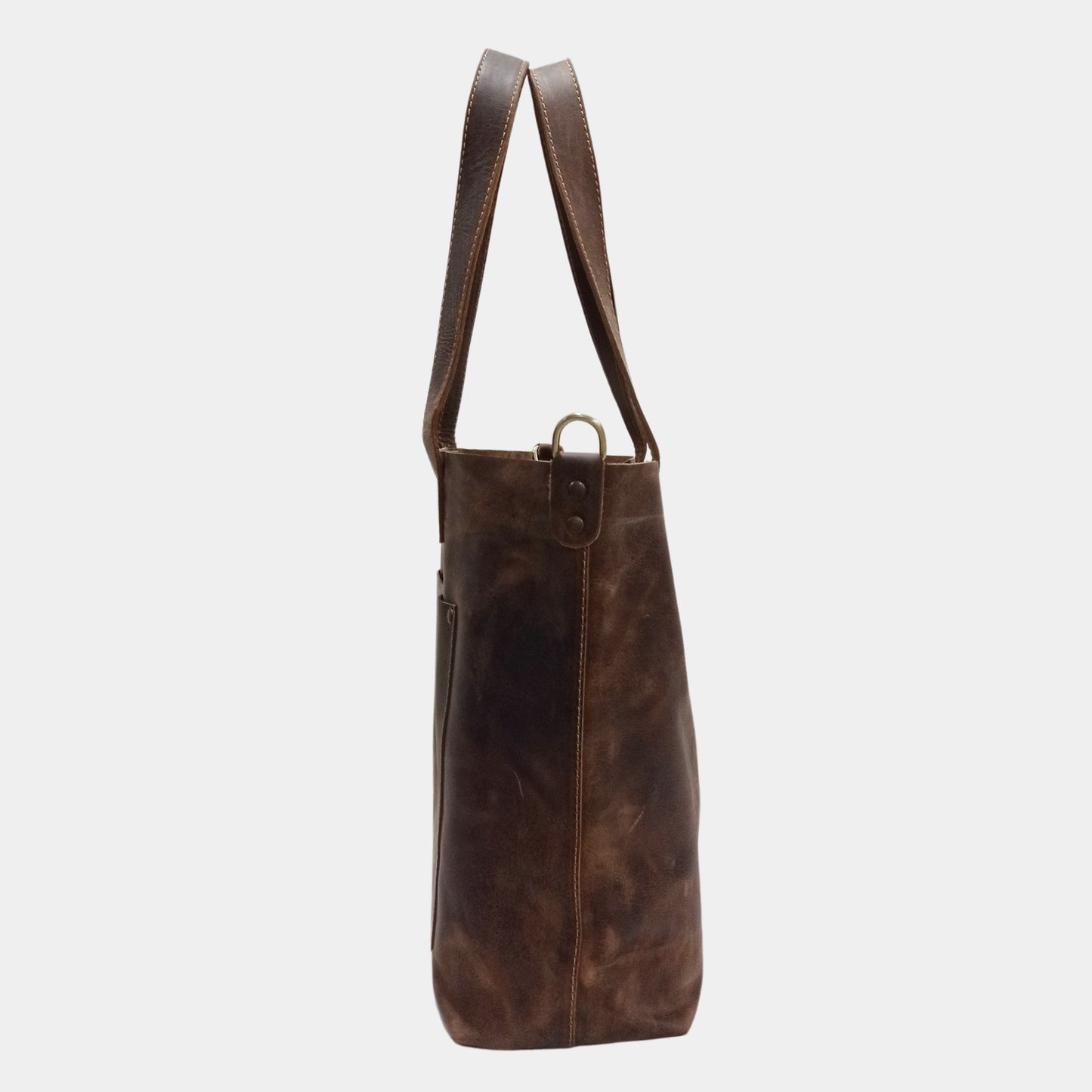 Side view of large dark brown leather tote featuring elegant brass hardware