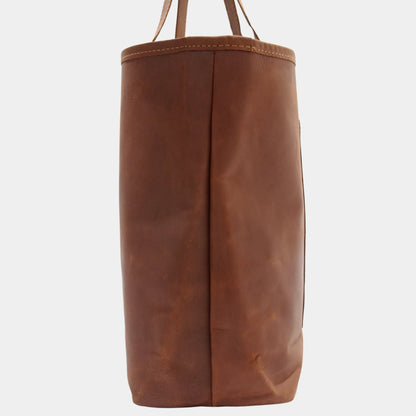 Side of elegant brown leather Mila Tote showing fine stitching and at side