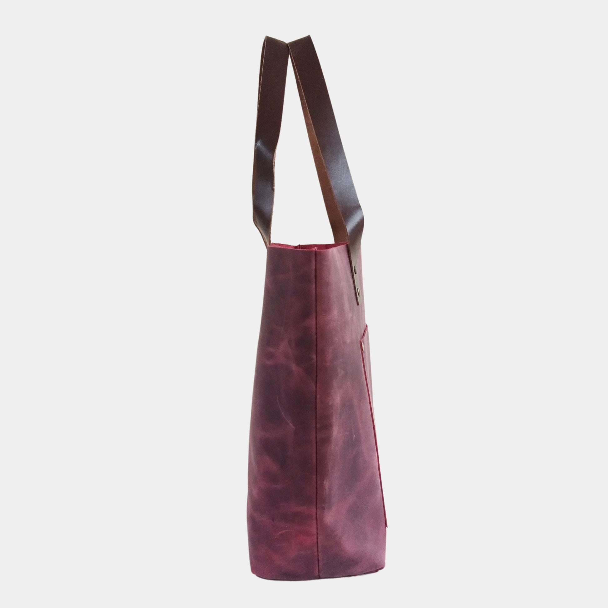 Side view of large burgundy leather bag showing fine stitching by our craftsmen