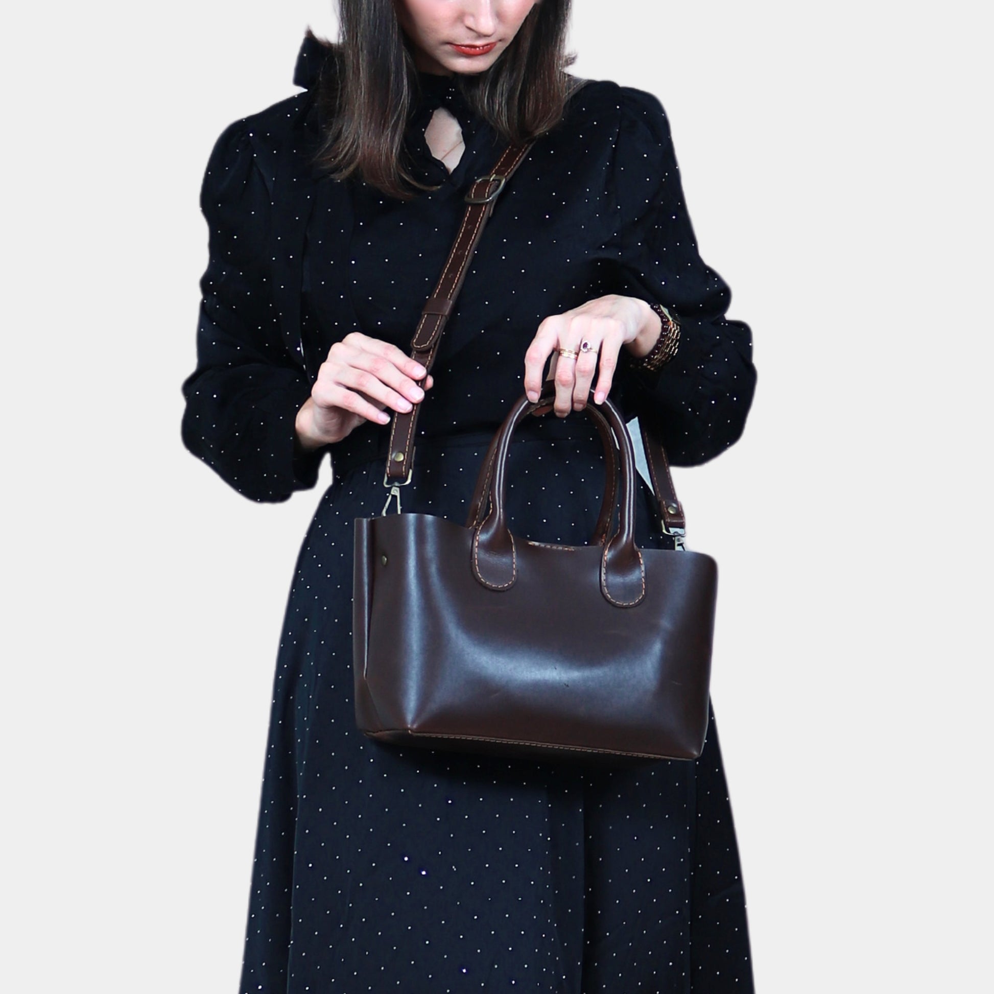 Woman in Black dress elegantly slinging Sienna Small Leather Tote and holding stylish soft grab handles