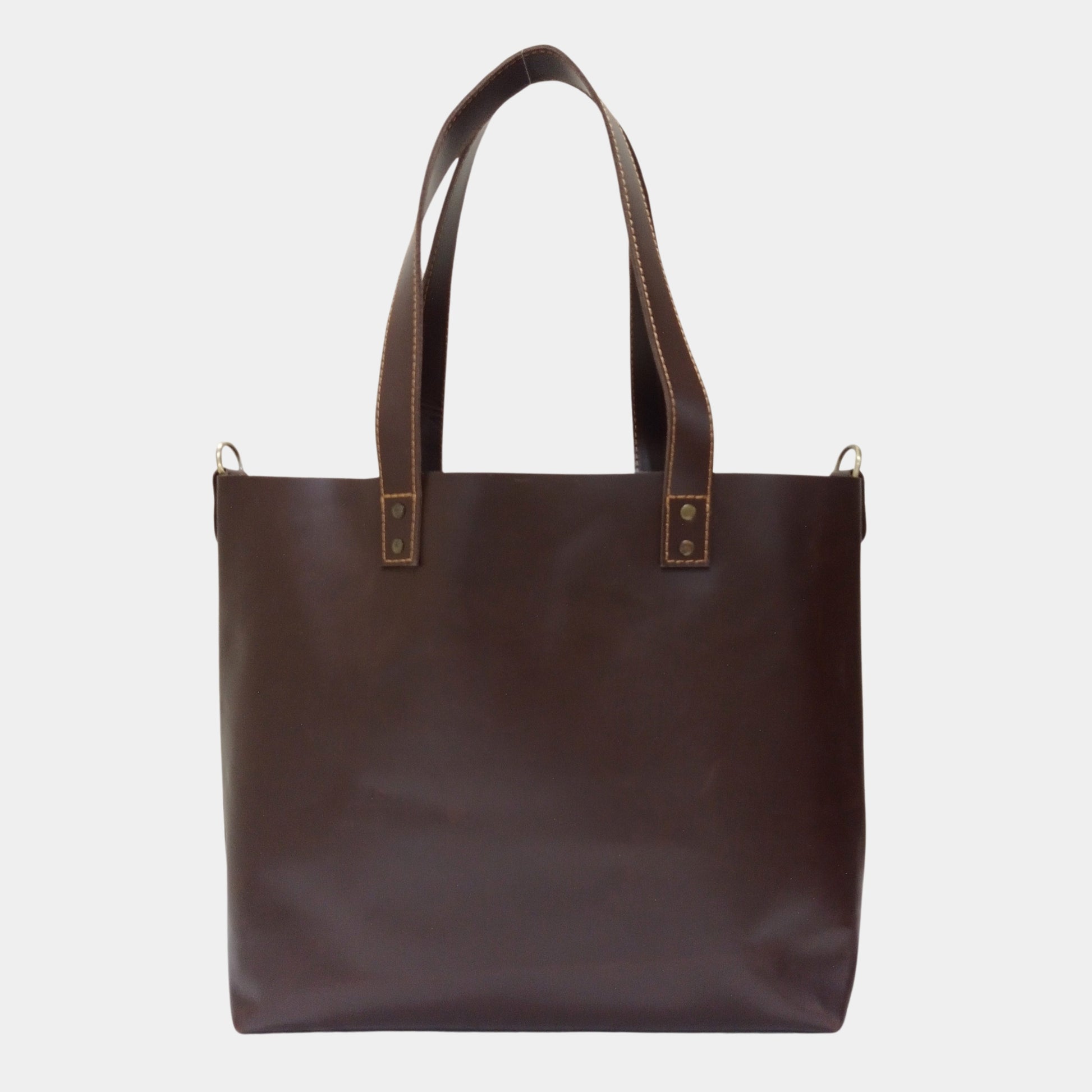 Backside of Ruby Dark Brown Leather Tote showing Brass Hardware and dual lined handles