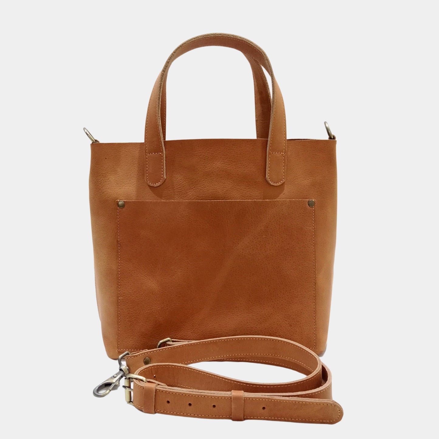 Elegant Olivia Leather Tote Bag with adjustable removable leather strap placed in front of bag