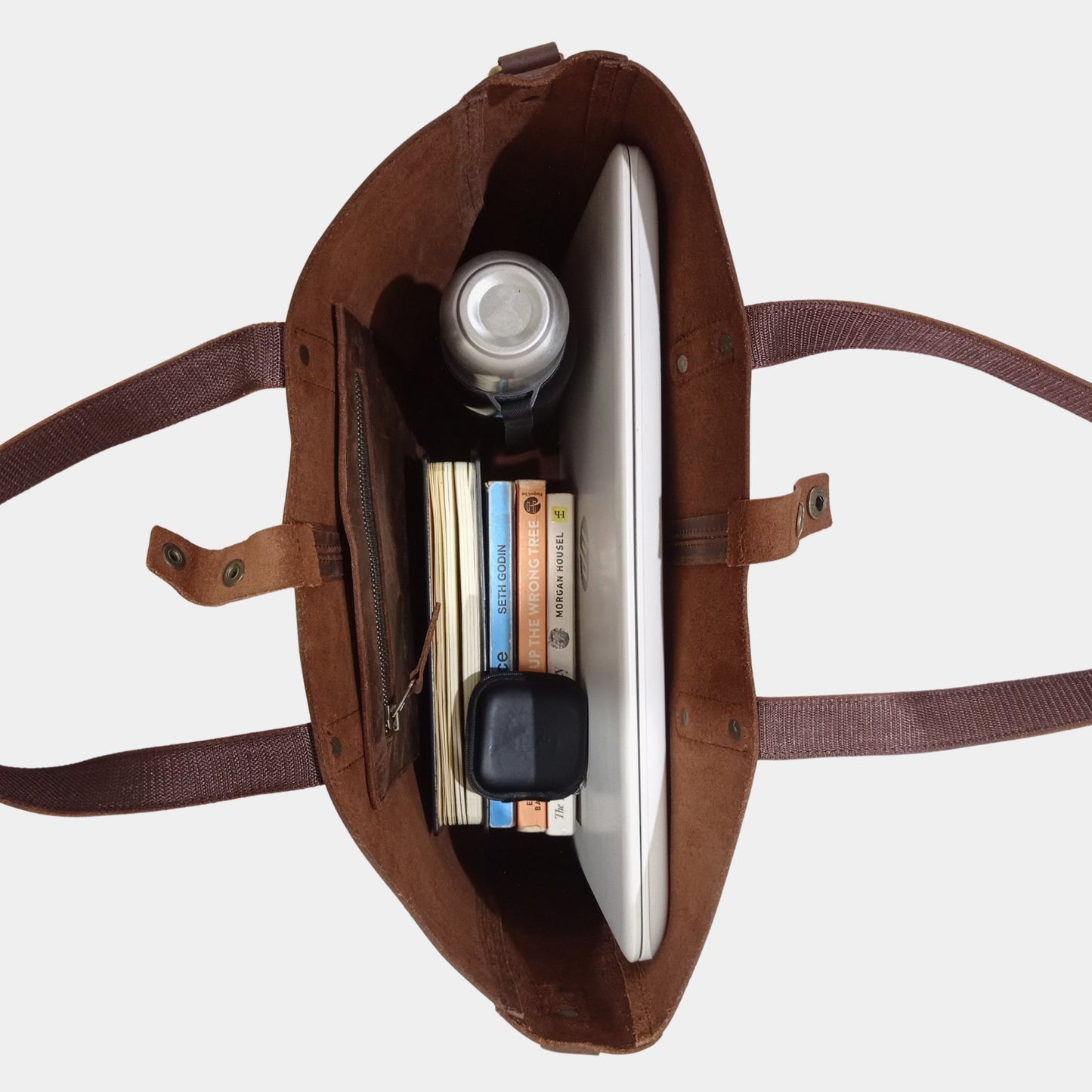 Interior of brown leather workbag sorting your office essentials books, water bottle 15" laptop with ease