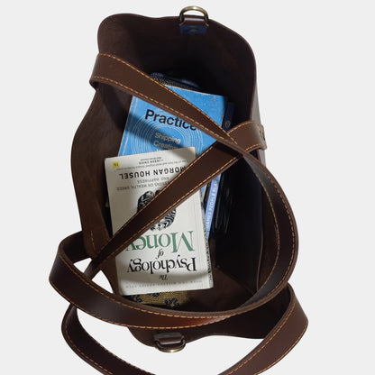 Books wallet and shirt elegantly placed inside Ruby Brown Leather Tote showing side hanging pocket